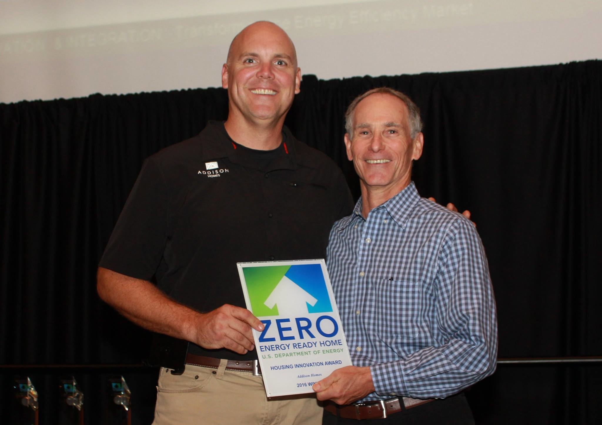 Addison Homes President Todd Usher receives the 2016 Housing Innovation Awards from DOE's Sam Rashkin
