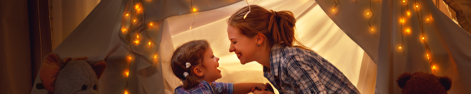 Mother and Daughter in Blanket Fort in Bedroom