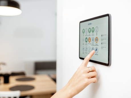 woman using tablet with smart home technology software